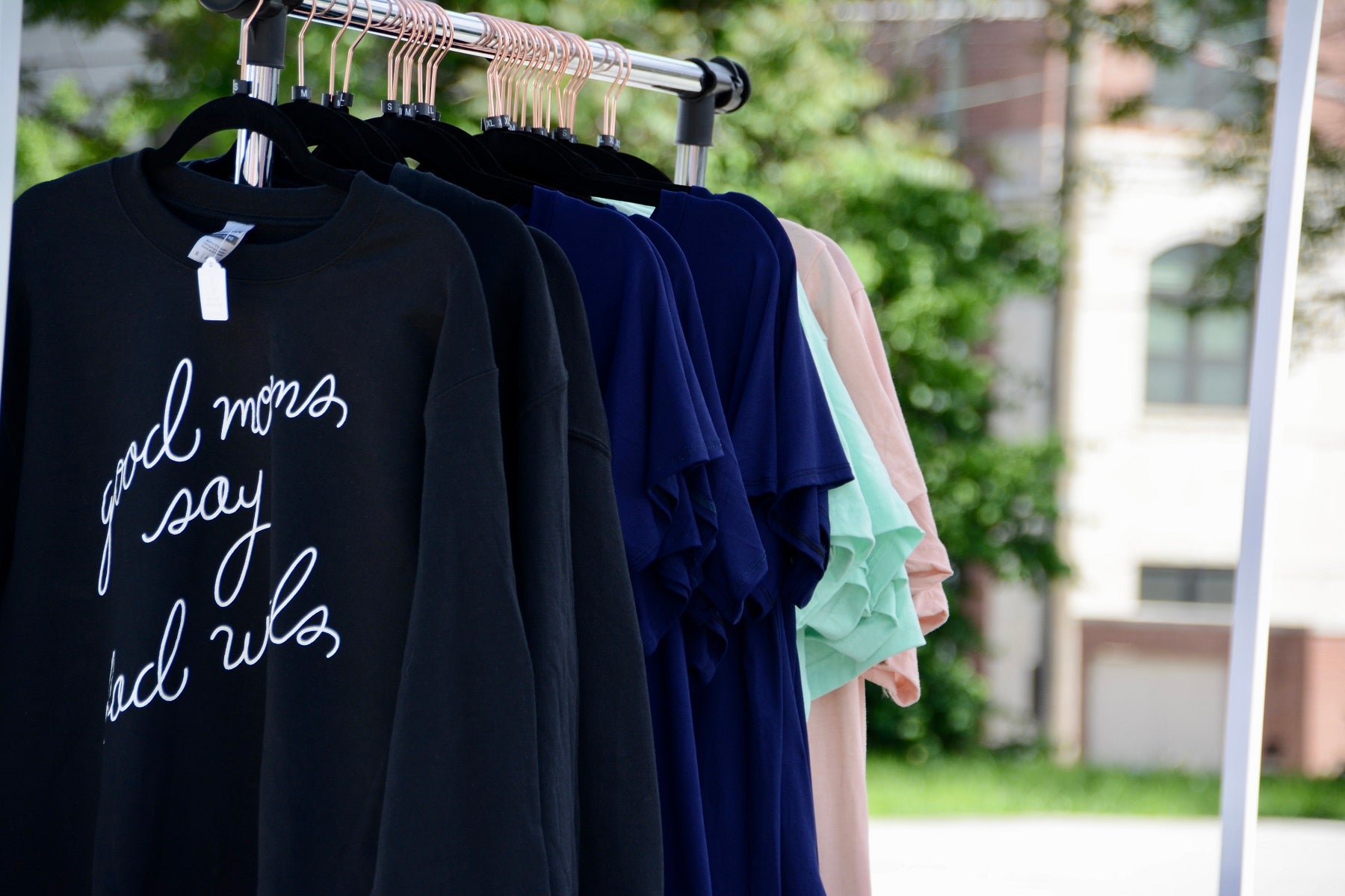 group of assorted t shirts hanging at imagewear